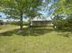 Quaint home with a large, green front lawn and mature trees providing ample shade at 248-A Gilbert Rd, Benson, NC 27504