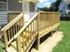 New wooden back deck with stairs leading to the lawn at 2662 Walas Ct, Creedmoor, NC 27522
