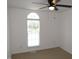 This bedroom features a ceiling fan, ample natural light, and neutral carpeting at 2662 Walas Ct, Creedmoor, NC 27522