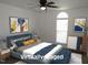 This staged bedroom includes a large window with modern decor and soft furnishings at 2662 Walas Ct, Creedmoor, NC 27522