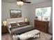This bedroom features a ceiling fan, ample natural light, and neutral decor at 2662 Walas Ct, Creedmoor, NC 27522