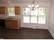 Open dining area with bright windows, chandelier, and hardwood floors, seamlessly connected to kitchen at 2662 Walas Ct, Creedmoor, NC 27522