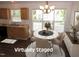 Bright dining area with natural light, modern chandelier, and stylish chairs with a view of outdoors at 2662 Walas Ct, Creedmoor, NC 27522