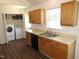 Bright kitchen features wood cabinets, stainless steel sink, and modern appliances, with laundry area at 2662 Walas Ct, Creedmoor, NC 27522