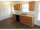 Efficient kitchen features light wood cabinets, black appliances, hardwood flooring, and bright natural light at 2662 Walas Ct, Creedmoor, NC 27522