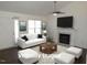 Bright and airy living room with a fireplace, neutral décor, a ceiling fan, and hardwood floors at 2662 Walas Ct, Creedmoor, NC 27522
