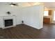 Comfortable living room with hardwood floors, fireplace, a partial wall, and access to kitchen at 2662 Walas Ct, Creedmoor, NC 27522
