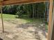 View from the unfinished patio, showing a gently sloping backyard and surrounding greenery at 299 Little Lady Trail, Zebulon, NC 27597