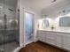 A stunning bathroom with a glass shower and double sink vanity with marble countertops at 300 W Roanoke Park Dr, Raleigh, NC 27608