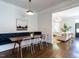 Bright dining area features wood floors, modern lighting, and view into living room at 300 W Roanoke Park Dr, Raleigh, NC 27608