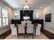 Elegant dining room with modern lighting, fireplace, and a view of the backyard at 300 W Roanoke Park Dr, Raleigh, NC 27608