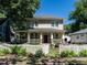 Charming two-story home features a welcoming front porch and a white picket fence at 300 W Roanoke Park Dr, Raleigh, NC 27608