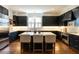 Stylish kitchen boasts dark cabinets, a marble island, and stainless steel appliances at 300 W Roanoke Park Dr, Raleigh, NC 27608