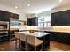 Stylish kitchen boasts dark cabinets, a marble island, and stainless steel appliances at 300 W Roanoke Park Dr, Raleigh, NC 27608