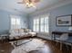Bright living room featuring hardwood floors, a cowhide rug and white sectional sofa at 300 W Roanoke Park Dr, Raleigh, NC 27608