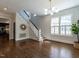 Bright living room featuring hardwood floors, modern lighting, and staircase at 300 W Roanoke Park Dr, Raleigh, NC 27608