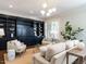 Living room features built-in shelving, hardwood floors, neutral paint, and lots of natural light at 300 W Roanoke Park Dr, Raleigh, NC 27608