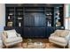 Living room features built-in shelving, hardwood floors, neutral paint, and lots of natural light at 300 W Roanoke Park Dr, Raleigh, NC 27608