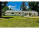 Wide shot of backyard featuring sunroom and manicured lawn at 303 Winhaven St, Roxboro, NC 27573