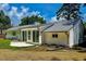 Backyard with a patio, home with white siding, and lush lawn and landscaping at 303 Winhaven St, Roxboro, NC 27573
