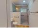 Bathroom with step-in shower, grab bars, and neutral tile at 303 Winhaven St, Roxboro, NC 27573