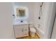 Updated bathroom featuring a vanity with illuminated mirror and a shower and tub with dark fixtures at 303 Winhaven St, Roxboro, NC 27573