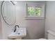 Bathroom with sink, and round mirror at 303 Winhaven St, Roxboro, NC 27573