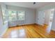 Bedroom featuring hard wood floors, white trim and a double window at 303 Winhaven St, Roxboro, NC 27573