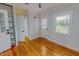 Bright bedroom featuring wood floors, crisp white trim, and large windows at 303 Winhaven St, Roxboro, NC 27573