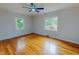 Sun-filled bedroom featuring hard wood floors and a ceiling fan at 303 Winhaven St, Roxboro, NC 27573
