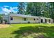 Spacious backyard with a well-maintained lawn and views of the home's back exterior at 303 Winhaven St, Roxboro, NC 27573