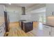 Open kitchen with island, stainless steel appliances, and views into the dining area at 303 Winhaven St, Roxboro, NC 27573