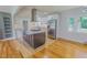 Kitchen island features a cooktop, barstool seating, stainless steel appliances and granite counters at 303 Winhaven St, Roxboro, NC 27573