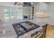 Gourmet kitchen island boasts a cooktop, modern appliances, and beautiful countertops at 303 Winhaven St, Roxboro, NC 27573