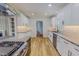 Well-lit kitchen boasting white cabinets, granite countertops, stainless steel appliances, and modern fixtures at 303 Winhaven St, Roxboro, NC 27573