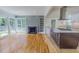 Open-concept space features hardwood floors, fireplace, and a gourmet kitchen with an island at 303 Winhaven St, Roxboro, NC 27573