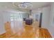 Open-concept living and kitchen area featuring hardwood floors, a fireplace, and stainless steel appliances at 303 Winhaven St, Roxboro, NC 27573