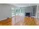 Bright living room featuring a fireplace, light grey wall accent, and hardwood flooring at 303 Winhaven St, Roxboro, NC 27573