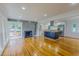 Spacious living room showcasing wood floors, a fireplace, and an open kitchen concept at 303 Winhaven St, Roxboro, NC 27573