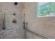 Step-in shower with tile surround, built-in niche, and grab bars at 303 Winhaven St, Roxboro, NC 27573