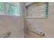 Step-in shower with tile surround, built-in niche, and grab bars at 303 Winhaven St, Roxboro, NC 27573