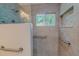 Step-in shower with tile surround, built-in niche, and grab bars at 303 Winhaven St, Roxboro, NC 27573