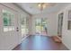 Bright sunroom featuring vinyl flooring, white walls, and lots of windows overlooking the backyard at 303 Winhaven St, Roxboro, NC 27573