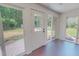Bright sunroom with large windows offering serene views of the backyard and outdoor access at 303 Winhaven St, Roxboro, NC 27573