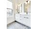 This bathroom features a double vanity, black hardware, sleek fixtures, and modern mirrors and lighting at 322 S Dixon Ave # R, Cary, NC 27511