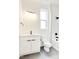 Modern bathroom features a white vanity, black hardware, sleek fixtures, and tub with vertical subway tile at 322 S Dixon Ave # R, Cary, NC 27511