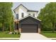 Modern two-story home featuring white siding, a dark gray garage, and a well-manicured front lawn at 322 S Dixon Ave # R, Cary, NC 27511