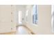 Bright hallway features hardwood floors, white walls, and a view through the front door at 322 S Dixon Ave # R, Cary, NC 27511