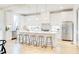 Bright modern kitchen featuring white cabinetry, a spacious island with seating, and stainless steel appliances at 322 S Dixon Ave # R, Cary, NC 27511