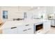 Gourmet kitchen with stainless oven, white cabinetry and quartz countertop island and dining area at 322 S Dixon Ave # R, Cary, NC 27511